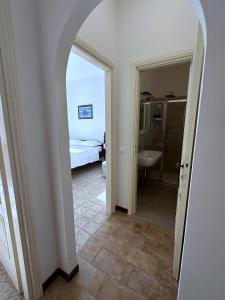 a hallway with a room with a bed and a bathroom at Terrace & Parking - Holiday Home near Fegina Beach in Monterosso al Mare