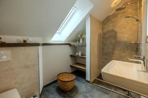 a bathroom with a sink and a bath tub at Hünzinger Dorfschmiede in Walsrode +88 photos