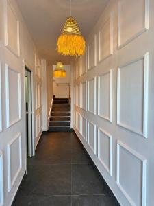 a hallway with stairs and a chandelier at Villa Maréa in Algeciras