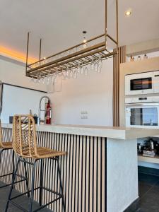 a kitchen with a counter with a table and chairs at Villa Maréa in Algeciras +12 photos