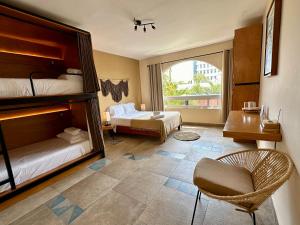 ein Schlafzimmer mit zwei Betten, einem Schreibtisch und einem Stuhl in der Unterkunft Pachamaya Holistic Wellness Boutique Hotel & Spa - Adults Only in Cancún + 73 Fotos