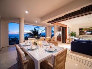 a dining room with a white table and chairs at Freshly Renovated, Spectacular Ocean Views, Ultra-Luxe Blue Ocean Suite H401 in Wailea