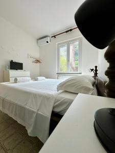 a bedroom with a large white bed with a window at Terrace & Parking - Holiday Home near Fegina Beach in Monterosso al Mare