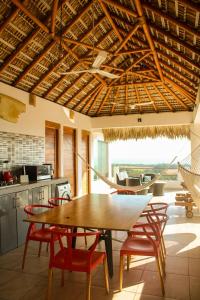 a dining room with a wooden table and chairs at Penthouse vistamar puerto escondido in Puerto Escondido