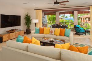 a living room with a white couch with colorful pillows at Ocean View Luxury, Castaway Cove C201, Wailea Beach Villas! in Wailea
