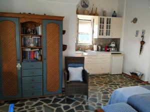 a bedroom with a bed and a cabinet and a chair at Agros in Varákkes