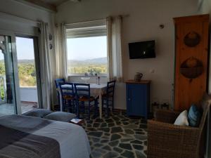 a bedroom with a bed and a table and chairs at Agros in Varákkes +7 photos
