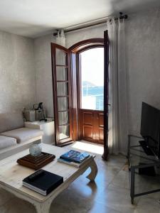 a living room with a couch and a coffee table at Castle81homes White , Sea view house in Marmaris