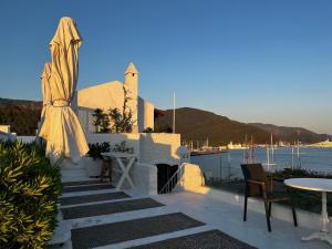 a patio with an umbrella and a table and chairs at Castle81homes White , Sea view house in Marmaris