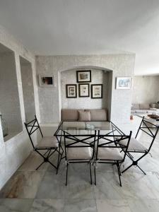 a living room with a glass table and chairs at Castle81homes White , Sea view house in Marmaris