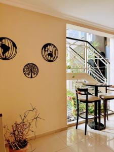 a dining room with a table and four decals on the wall at Hotel Aire de Patagonia in Río Gallegos +36 photos