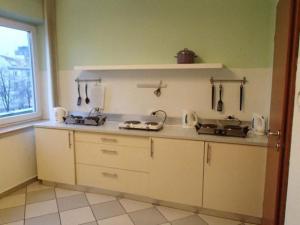 a kitchen with a sink and a counter top at Hostel 01 in Częstochowa