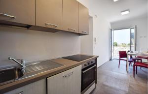 a kitchen with a sink and a stove top oven at 1 Bedroom Gorgeous Home In Castellabate in Castellabate