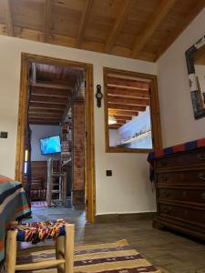 a room with a bed and a dresser and a mirror at Essaouira wood house in Essaouira