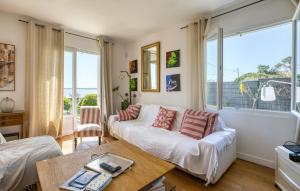 a living room with a couch and a table at Awesome Home In Saint-Trojan-Les-Bains in Saint-Trojan-les-Bains