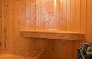 a wooden paneled sauna with a wooden shelf at Cozy Home In Rudkøbing With Sauna in Spodsbjerg