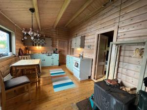 a kitchen with wooden walls and a table and a stove at Lofoten MidnightSun Lodge in Sandsletta +48 photos