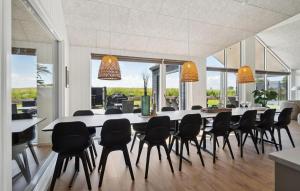 a large dining room with a long table and chairs at Lovely Home In Otterup With Sauna in Otterup