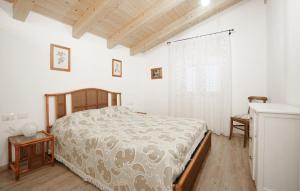 a bedroom with a bed and a wooden floor at Amazing Home In Imperia With Wifi in Imperia