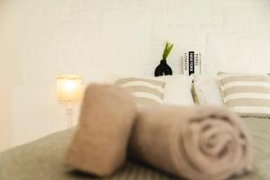 a person laying on a bed next to a lamp at Stylish Mykonian apartment Semi-Private huge Pool in Houlakia +26 photos