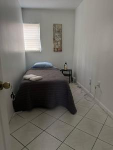 a bedroom with a bed in a white room at Layover Miami International Airport in Miami