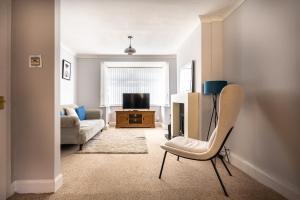 a living room with a chair and a television at Royal Retreat in Redcar