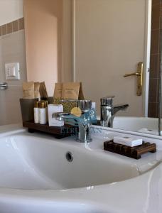 a bathroom sink with a tray of items on it at Etruscan Blue House in Piombino