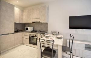 una cucina con tavolo con sedie e forno a microonde di 1 Bedroom Cozy Apartment In Rapallo a Rapallo Altre 5 foto
