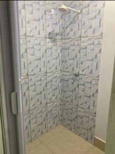 a shower with a glass door in a bathroom at Casa Marajó Centro de Belém COP30 in Belém +4 photos
