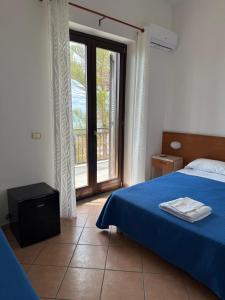 Postel nebo postele na pokoji v ubytování Hotel Acciaroli