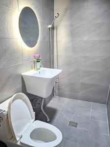 a bathroom with a toilet and a sink and a mirror at URBAN KS Stay in Seoul