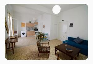 a living room with a blue couch and a table at The SPiTi Project 35 in Kavála