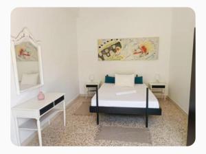 a bedroom with a bed and a desk and a mirror at The SPiTi Project 35 in Kavala
