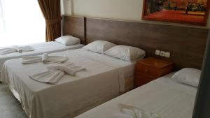 A bed or beds in a room at Ozgun Apart Hotel