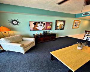 a living room with a couch and a table at Wyndham Ocean Walk -1302 Vacation in Comfort and luxury - 1BR Direct Oceanfront in Daytona Beach