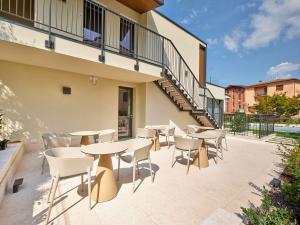 a group of tables and chairs on a patio at Villa San Zeno Rooms in Bardolino