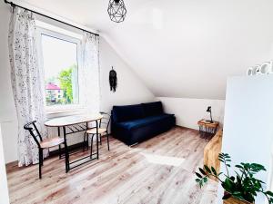 a living room with a blue couch and a table at Apartament Salton in Bochnia