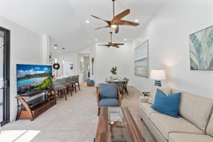 Una sala de estar con un sofá y un televisor. en Grand Champions 106, en Wailea