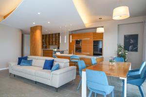 a living room with a couch and a table and chairs at Onda del Mare in Mazzeo