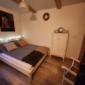 a bedroom with a bed and a clock on the wall at Siedlisko Magnolia in Wólka Sulejowska