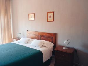 a bedroom with a bed and two pictures on the wall at Cascina Longoria in Neive +48 photos
