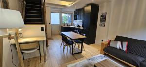 a small living room with a table and a couch at Appartement de charme sur golf in Buzet-sur-Tarn