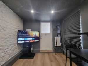 a living room with a flat screen tv on a wall at Romantic Room proche de Paris in Choisy-le-Roi