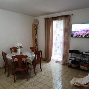 a dining room with a table and chairs and a window at Villa Mont D'Or in Manosque