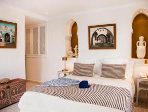 a bedroom with a bed with a blue hat on it at Westminster moroc style in London