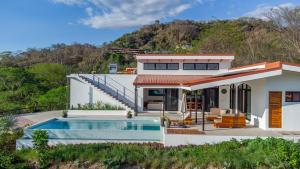 a house with a swimming pool in front of it at Luxury villa in Samara beach- Casa Armonía in Sámara