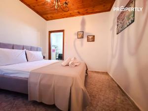 a bedroom with a bed with a pink towel on a table at Cypress Seaside Apartment #PROPERTLY in Nea Kallikrateia