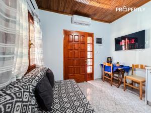 a bedroom with a bed and a table and a desk at Cypress Seaside Apartment #PROPERTLY in Nea Kallikrateia