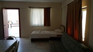 A bed or beds in a room at Ozgun Apart Hotel