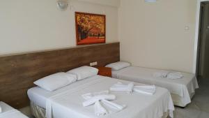 A bed or beds in a room at Ozgun Apart Hotel